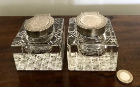 PAIR OF RECTANGULAR CUT GLASS INKWELLS WITH SILVER HINGED COVERS