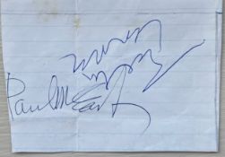 Clipped piece of lined paper signed by John Lennon and Paul McCartney obtained in Weston-super-
