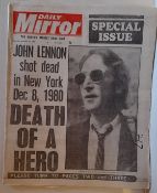 A collection of scrapbooks and Lennon newspapers