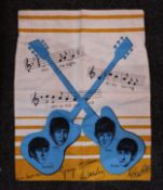 Section of Dutch Beatles dress material features guitars with Beatles faces and musical notes and