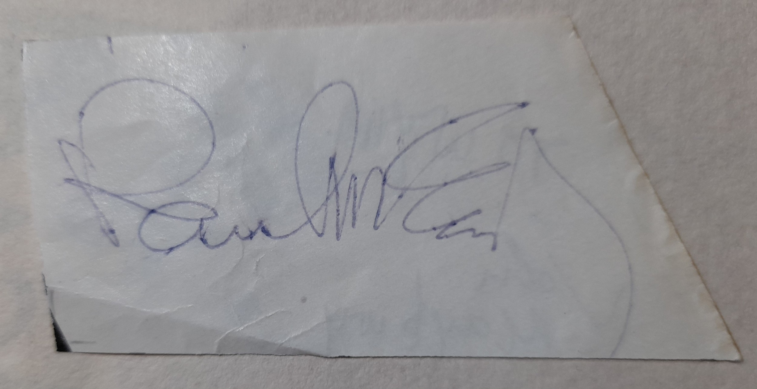 Clipped piece of paper signed by Paul McCartney