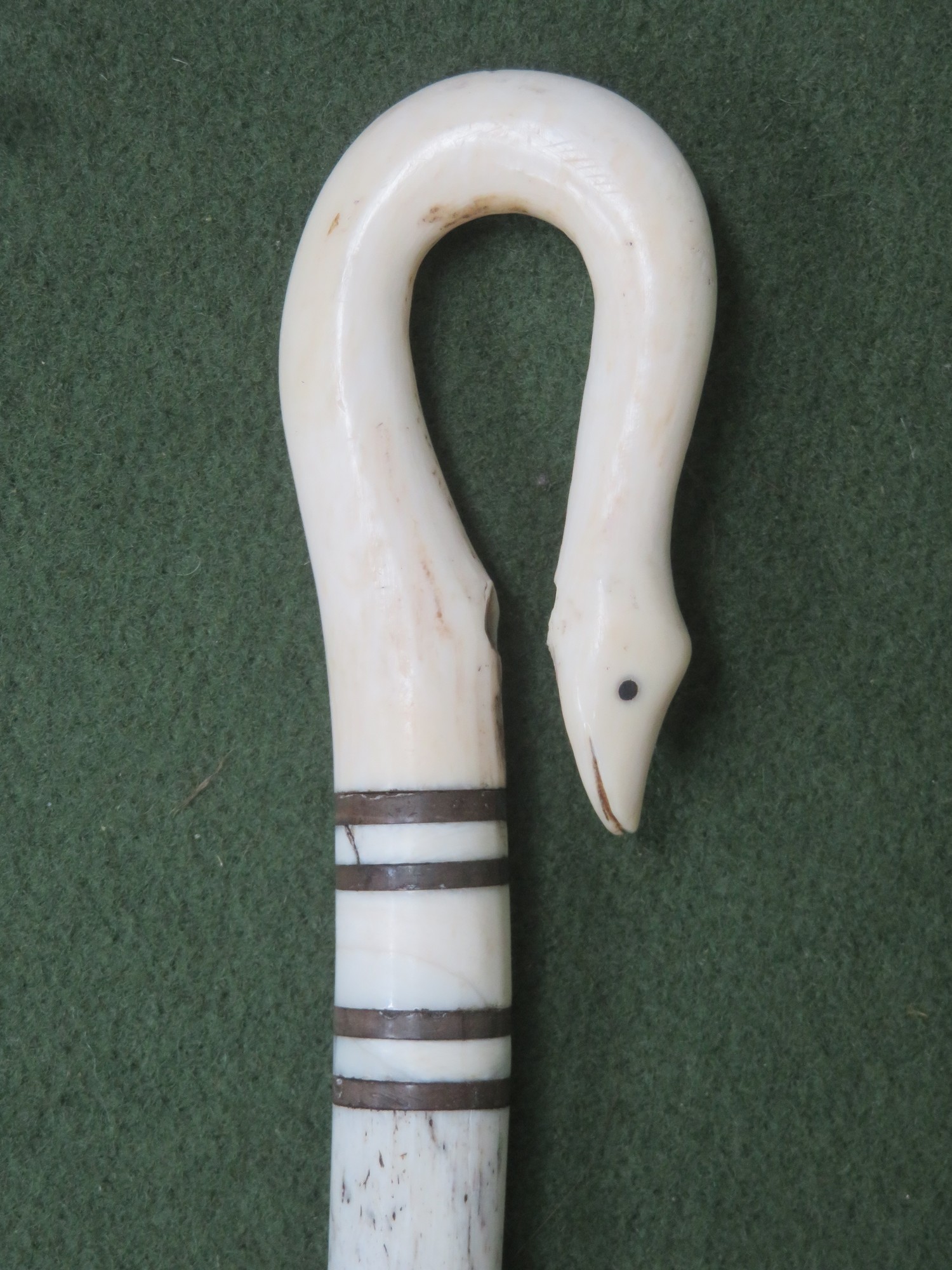 18th century speckled whale bone turned walking stick, with hand carved ivory serpent form handle.