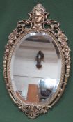 20th century gilt metal framed and bevelled oval wall mirror. Approx. 67cms x 39.5cms