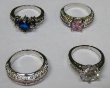 Four various pretty white metal ladies dress rings, set with various coloured stones