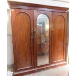 Victorian mahogany triple combination wardrobe, fitted with central mirrored door. Approximately.