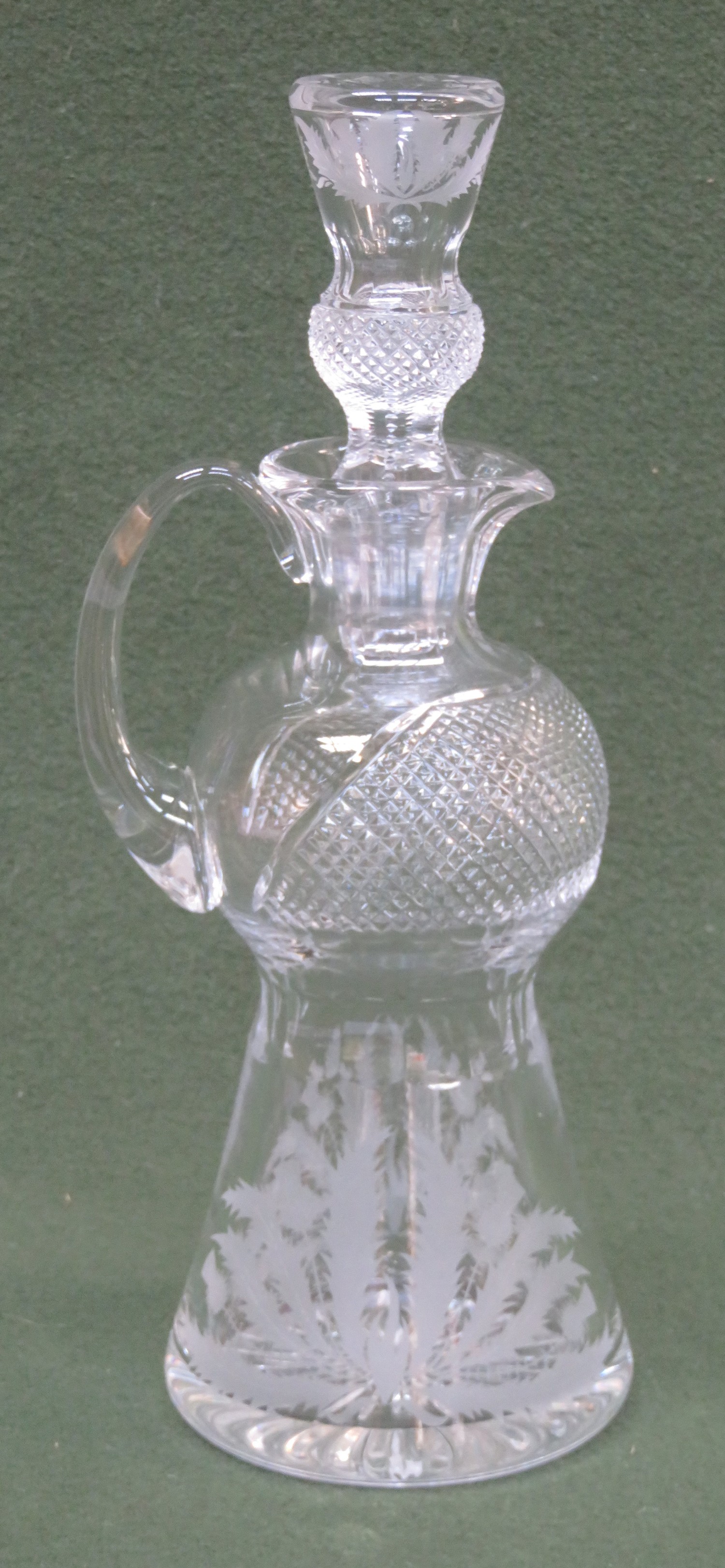 Edinburgh crystal etched thistle pattern decanter with handle and pouring spout. Approx. 32cm High