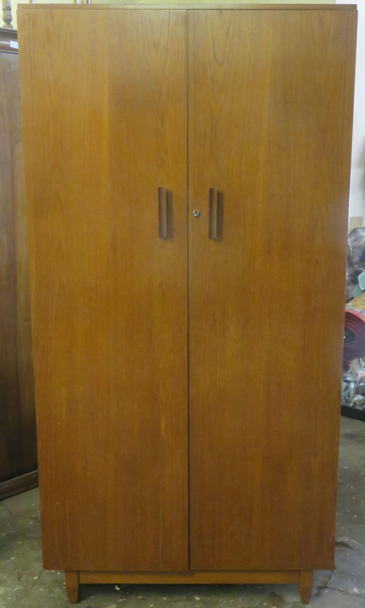 Mid 20th century teak two door wardrobe, Bearing a makers label 'BDS'. Approx. 179cms H x 91cms W