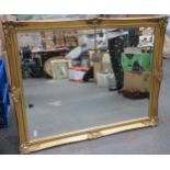 20th century gilded and bevelled wall mirror. App. 91 x 115cm