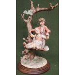 Bruno Merli for Capodimonte - glazed and unglazed ceramic figure group depicting a young girl and