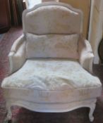 French style upholstered and carved framed low seated armchair. App. 91cm H x 86cm W x 102cm D