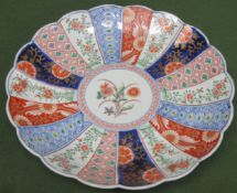 Oriental wave edged ceramic charger, decorated in the Imari palette. App. 31cm Diameter