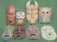 Eight various handpainted and carved treen tribal style wall masks