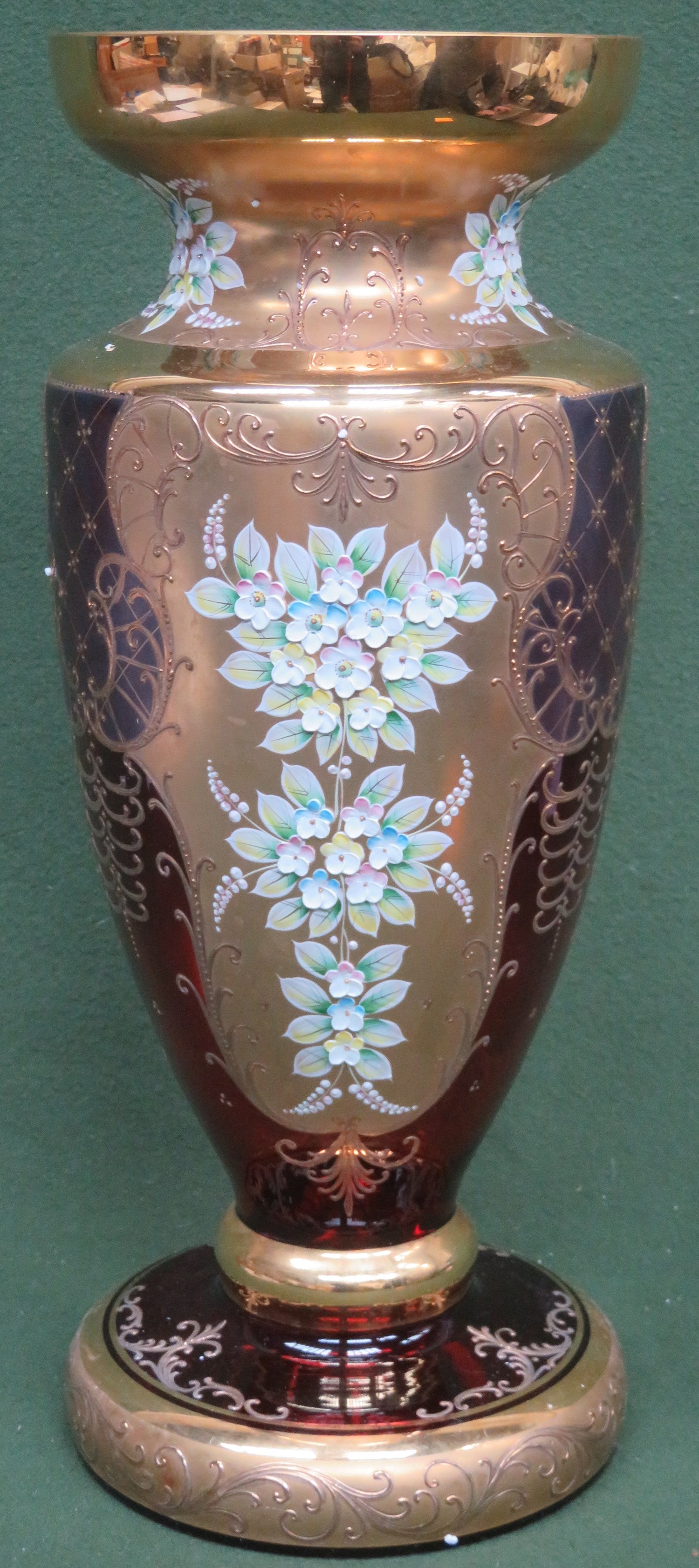 Impressive ruby venetian coloured venetian glass vase, with heavily gilded and floral decoration.