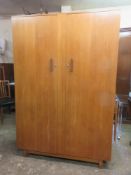 Mid 20th century teak two door wardrobe, Bearing a makers label 'BDS'. Approx. 179cms H x 120.5cms W