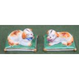 Pair of small late 19th/ early 20th century ceramic figures, depicting recumbent dogs on cushions,