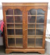 20th century walnut veneered two door glazed bookcase. Approx. 112cms H x 88cms W x 30cms D