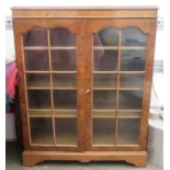 20th century walnut veneered two door glazed bookcase. Approx. 112cms H x 88cms W x 30cms D