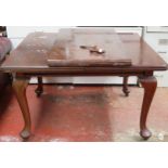 Victorian mahogany wind out dining table with one leaf, on cabriole supports.