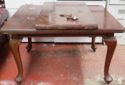 Victorian mahogany wind out dining table with one leaf, on cabriole supports.