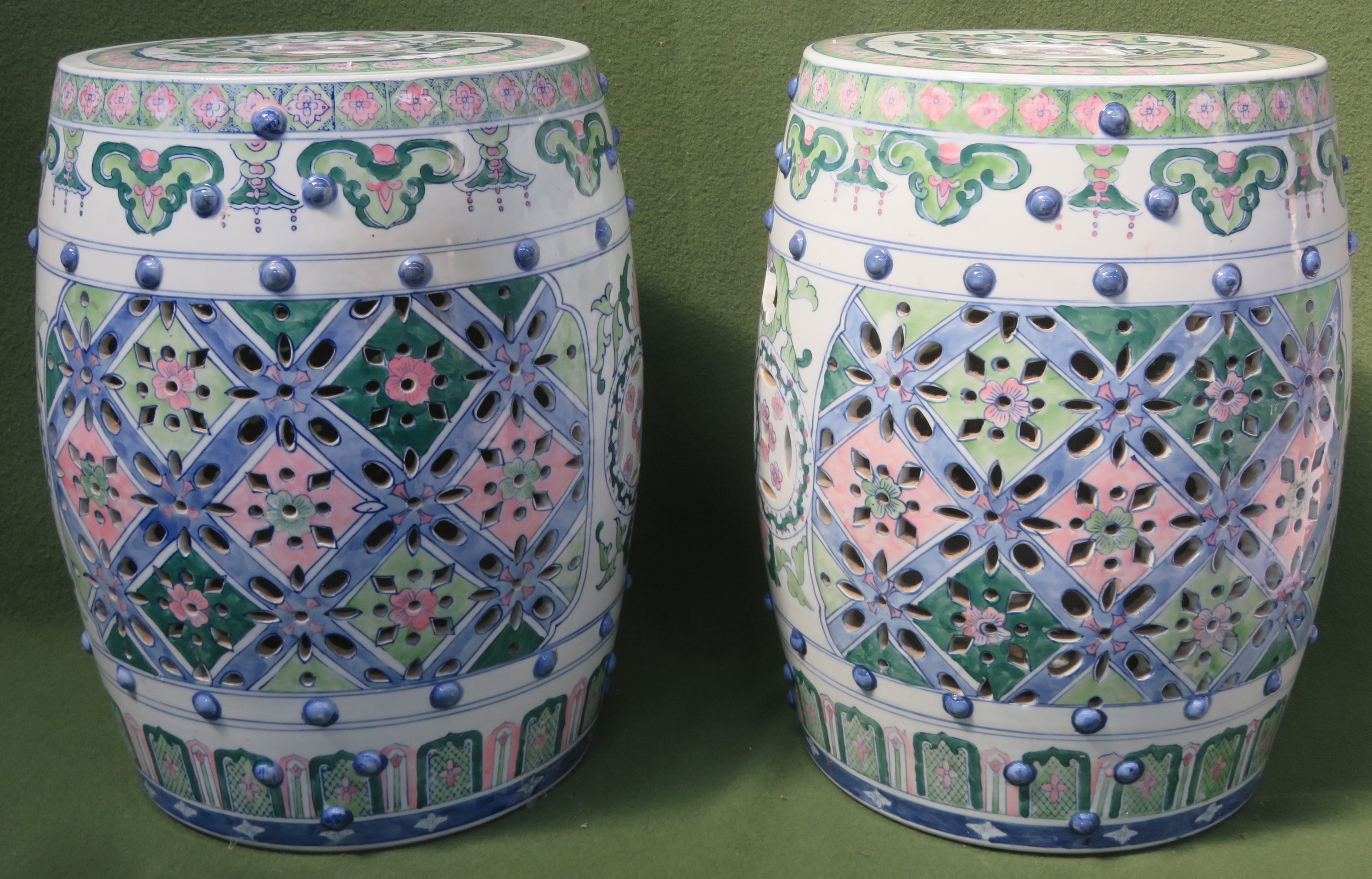Two similar Oriental handpainted and piercework decorated ceramic barrel form window seats.