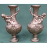 Pair of Victorian heavily gilded cast metal vases, with relief decorated cherubs and floral swags.