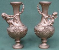 Pair of Victorian heavily gilded cast metal vases, with relief decorated cherubs and floral swags.