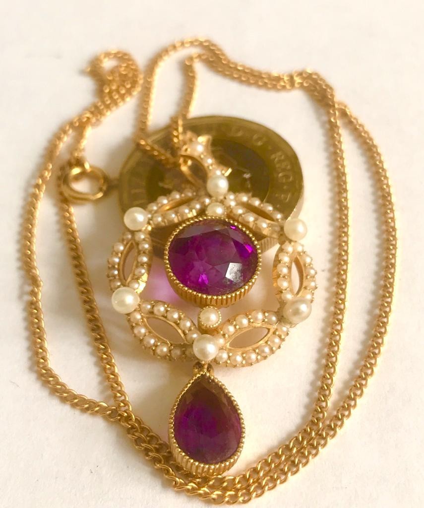 UNHALLMARKED GOLD COLOURED METAL PENDANT SET WITH AMETHYST COLOURED STONES AND SEED PEARLS PLUS GOLD