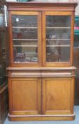 Victorian mahogany two door glazed bookcase, fitted with two drawers and cupboard doors below.