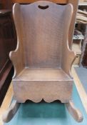 Childs antique oak rocking chair. Approximately. 58cm H x 34cm W