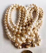CULTURED PEARL THREE STRAND NECKLACE HAVING 9ct GOLD CLASP