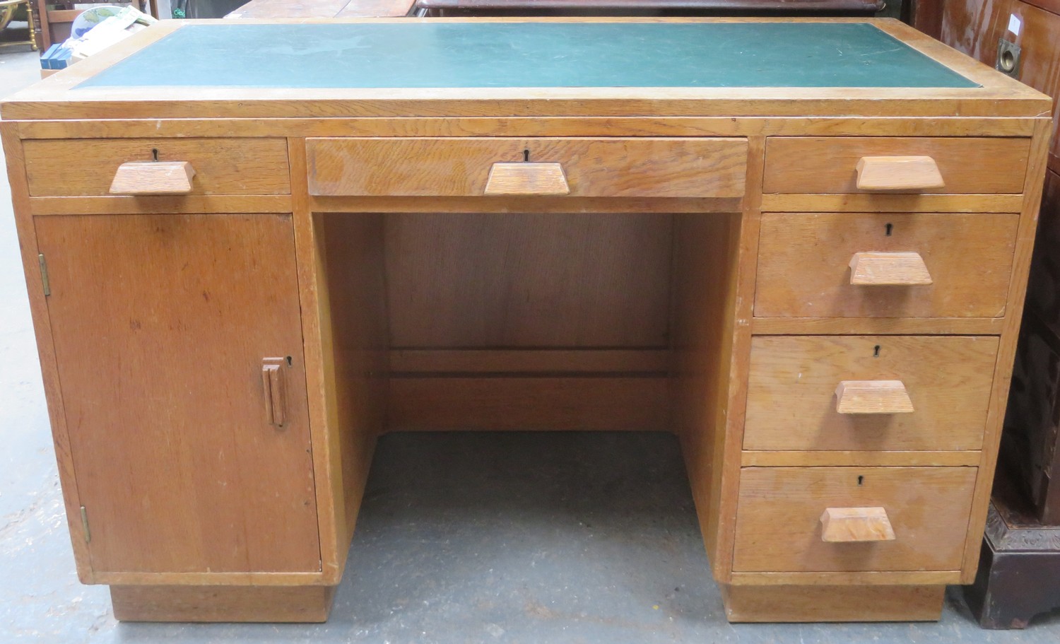 Art Deco style oak kneehole writing desk with leather inserts. Approximately. 76cm H x 121.5cm W x