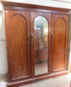 Victorian mahogany triple combination wardrobe, fitted with central mirrored door. Approximately.