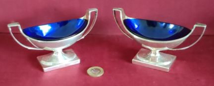 PAIR OF GEORGE III HALLMARKED SILVER NAVETTE FORM TWO HANDLED OPEN SALTS WITH BLUE GLASS LINERS,