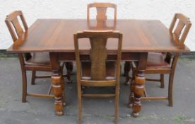 Early 20th century oak draw leaf dining table plus four chairs. Approx. 74cm H x 148cm W x 90cm D