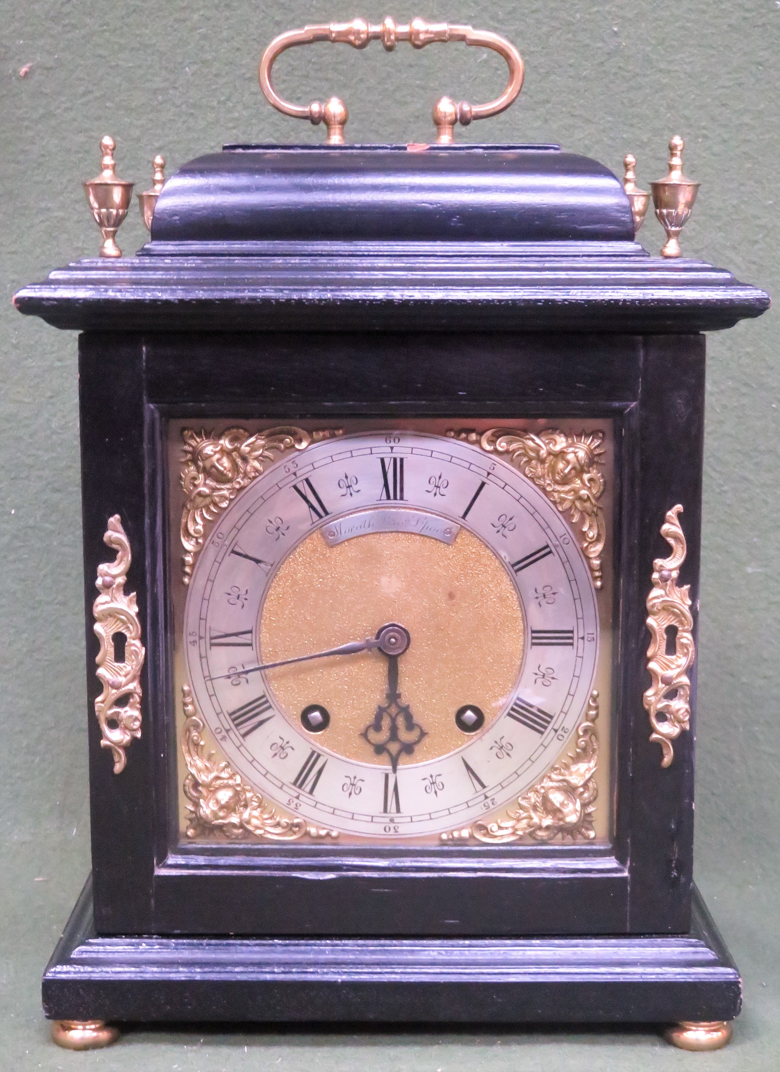 Early 20th century Ebonised Mantle clock, with ormulu brass dial, brass veneer and brass finials, by