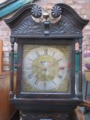 Carved Ebonised Oak cased longcase clock, with square brass and rolling moon dial by Thomas