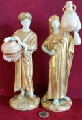 PAIR OF ROYAL WORCESTER BLUSH IVORY HEAVILY GILDED LADY AND GENT FIGURES CARRYING WATER JUGS, BOTH