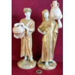 PAIR OF ROYAL WORCESTER BLUSH IVORY HEAVILY GILDED LADY AND GENT FIGURES CARRYING WATER JUGS, BOTH