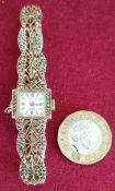 DELVINA GENEVE 17 JEWEL WRISTWATCH WITH FILIGREE STYLE STRAP AND SURROUNDED WITH STONES