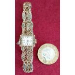 DELVINA GENEVE 17 JEWEL WRISTWATCH WITH FILIGREE STYLE STRAP AND SURROUNDED WITH STONES