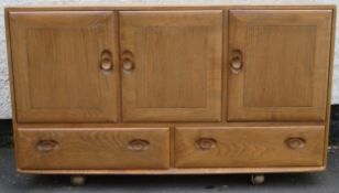 Ercol mid 20th century light oak three door sideboard with two drawers below. Approx. 76cm H x 129cm