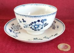 LIVERPOOL POTTERY HANDPAINTED AND GLAZED BLUE AND WHITE TEA BOWL AND SAUCER WITH FLORAL DECORATION