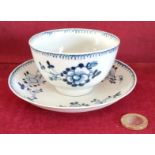 LIVERPOOL POTTERY HANDPAINTED AND GLAZED BLUE AND WHITE TEA BOWL AND SAUCER WITH FLORAL DECORATION