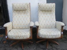 Pair of Ercol mid 20th century oak framed upholstered swivel armchairs. Approx. 114cms H