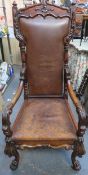 19th century heavily carved mahogany framed and leather upholstered throne type armchair on ball and