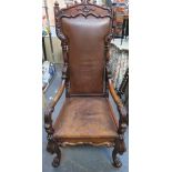 19th century heavily carved mahogany framed and leather upholstered throne type armchair on ball and