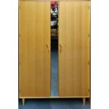 A 1960's Meredew golden oak double wardrobe, W. 120cm.