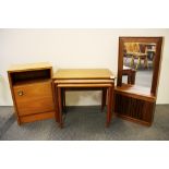 A nest of three 1970's teak tables together with a teak mirror cabinet and a teak veneered bedside