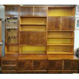 A large 1970's maple veneered sectional bookcase cabinet with an L shaped corner unit.