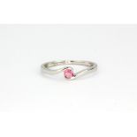 A 9ct white gold crossover ring set with a pink tourmaline, (P).